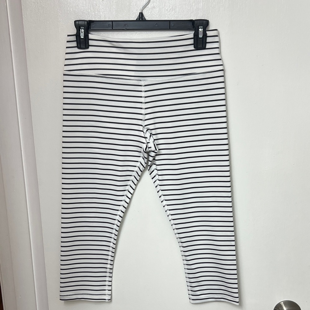 Scorpio Sol cropped leggings, size small, white with thin black stripes